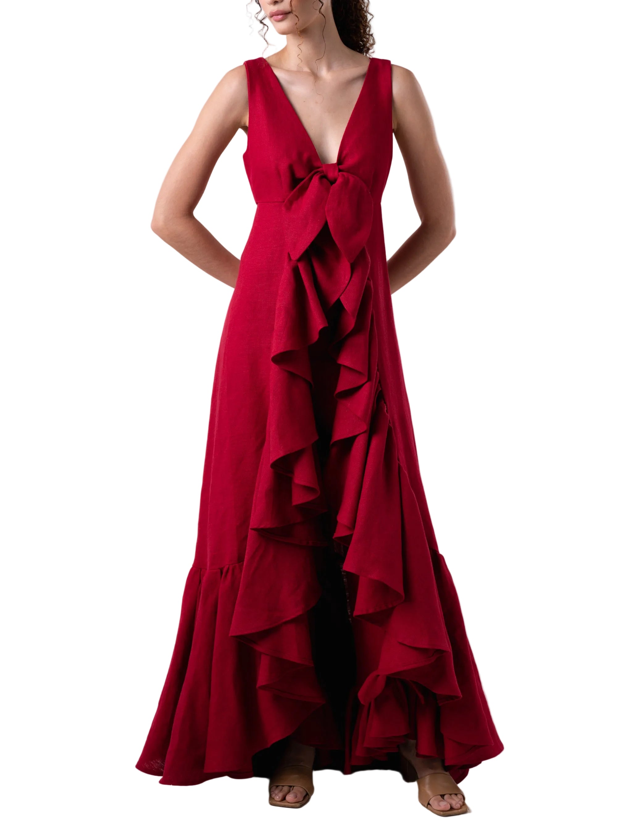 Top that features a sleeveless V neck cut with exaggerated train with ruffle detail.