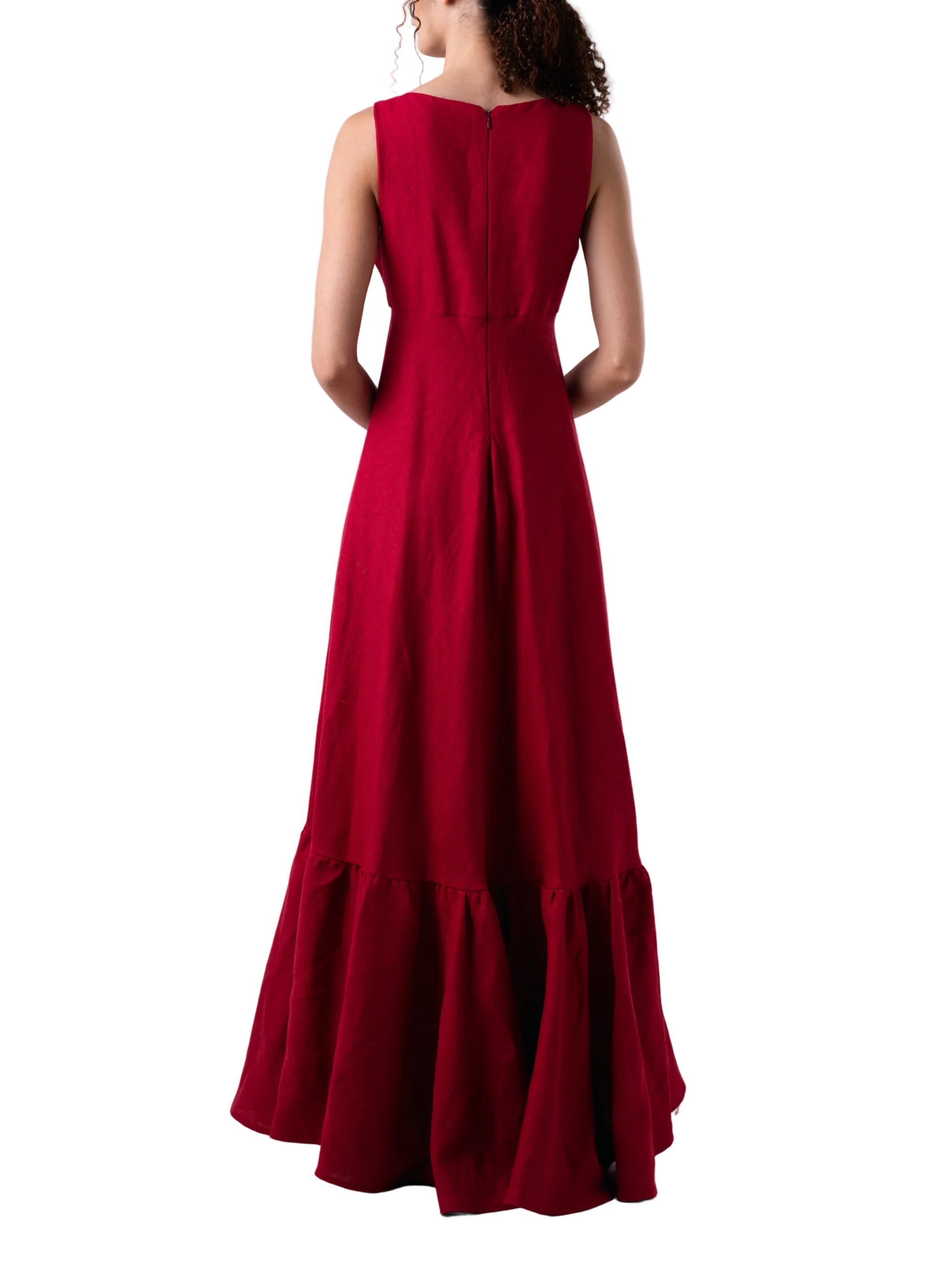 Top that features a sleeveless V neck cut with exaggerated train with ruffle detail.