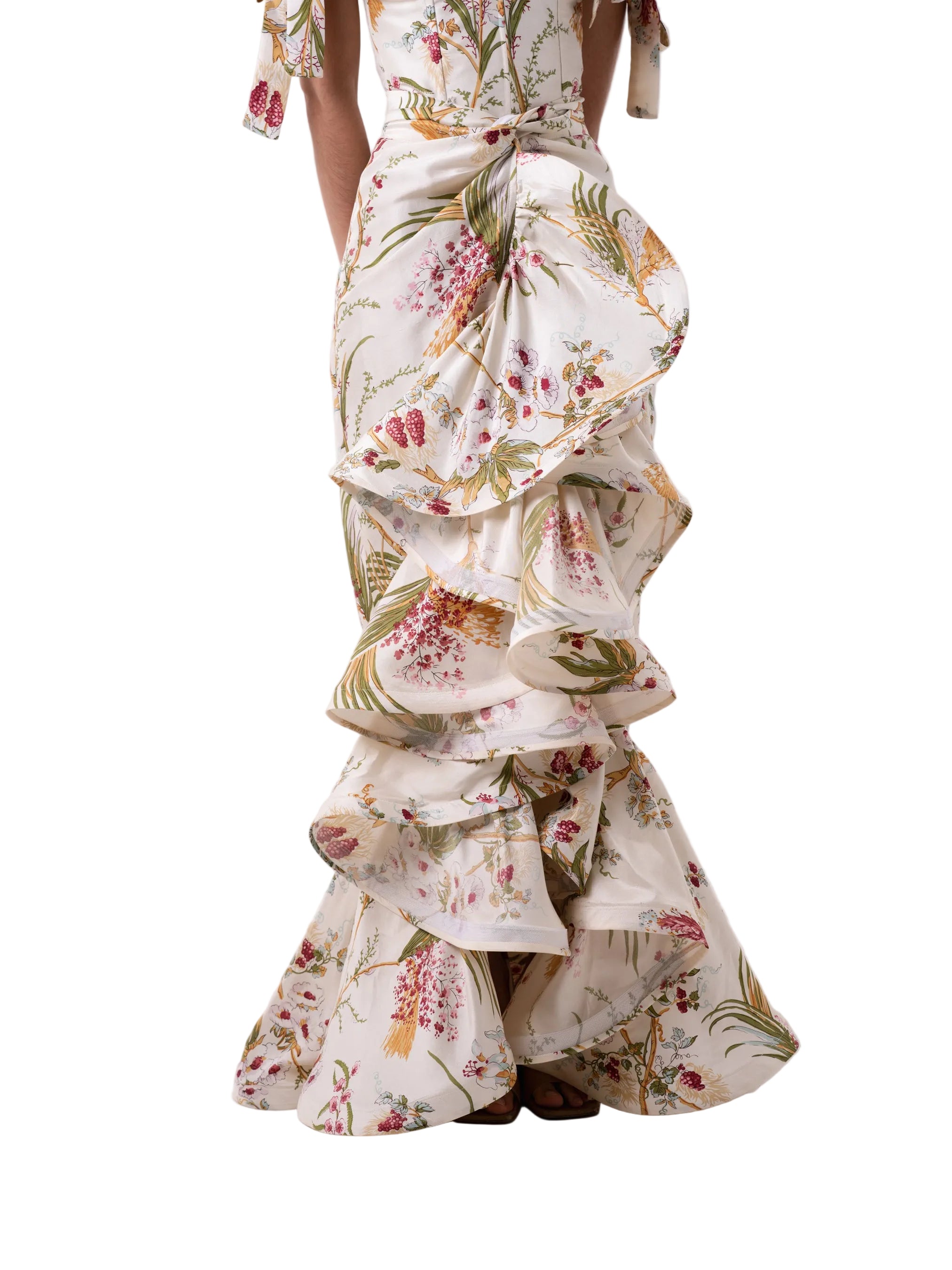 Skirt that features a wrap around floor length silhouette with circular ruffle down the center and hem.