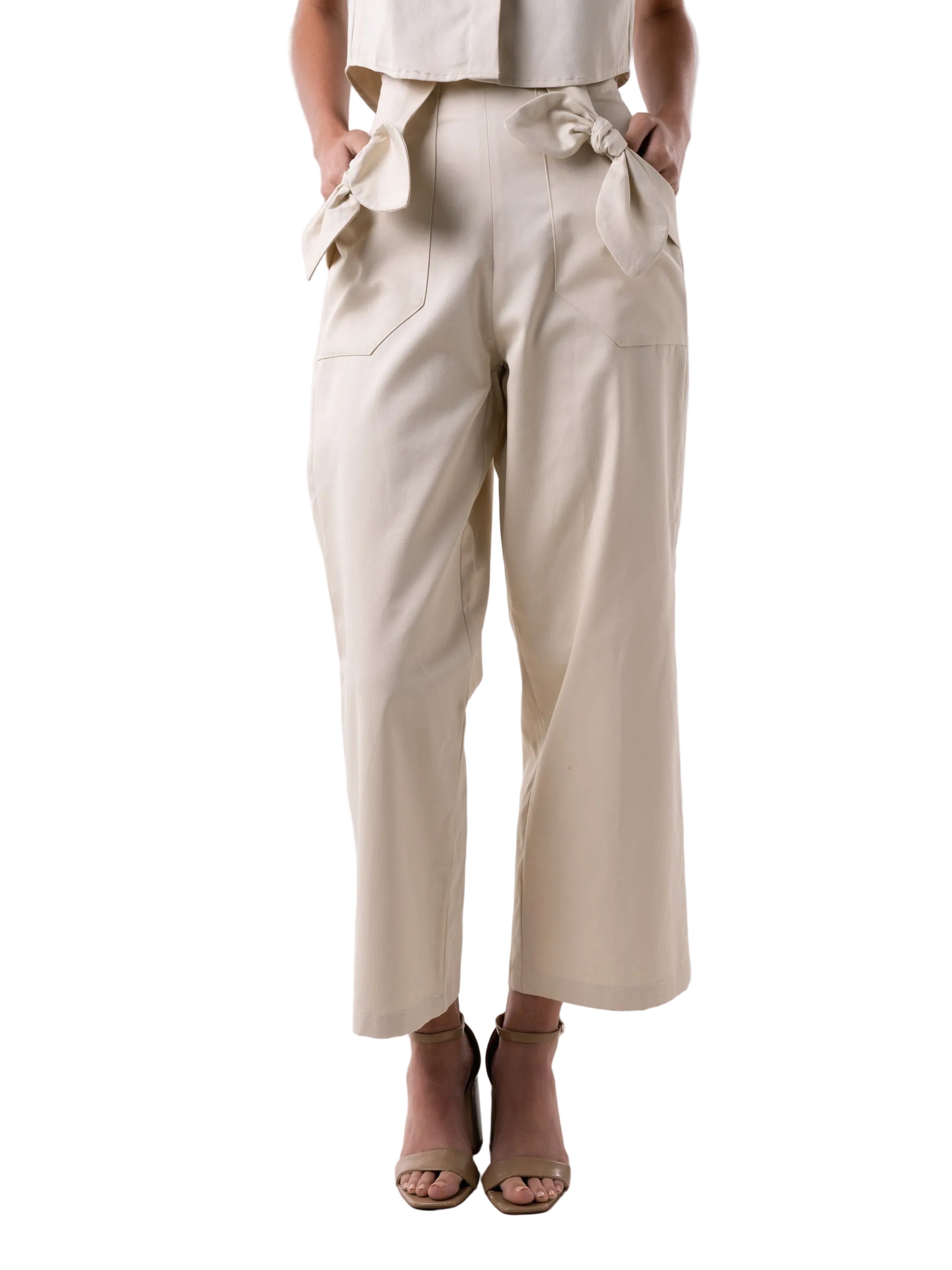 Pant with high waisted relaxed silhouette, elastic back waist band, side zipper closure, and front pockets adorned with knot details.
