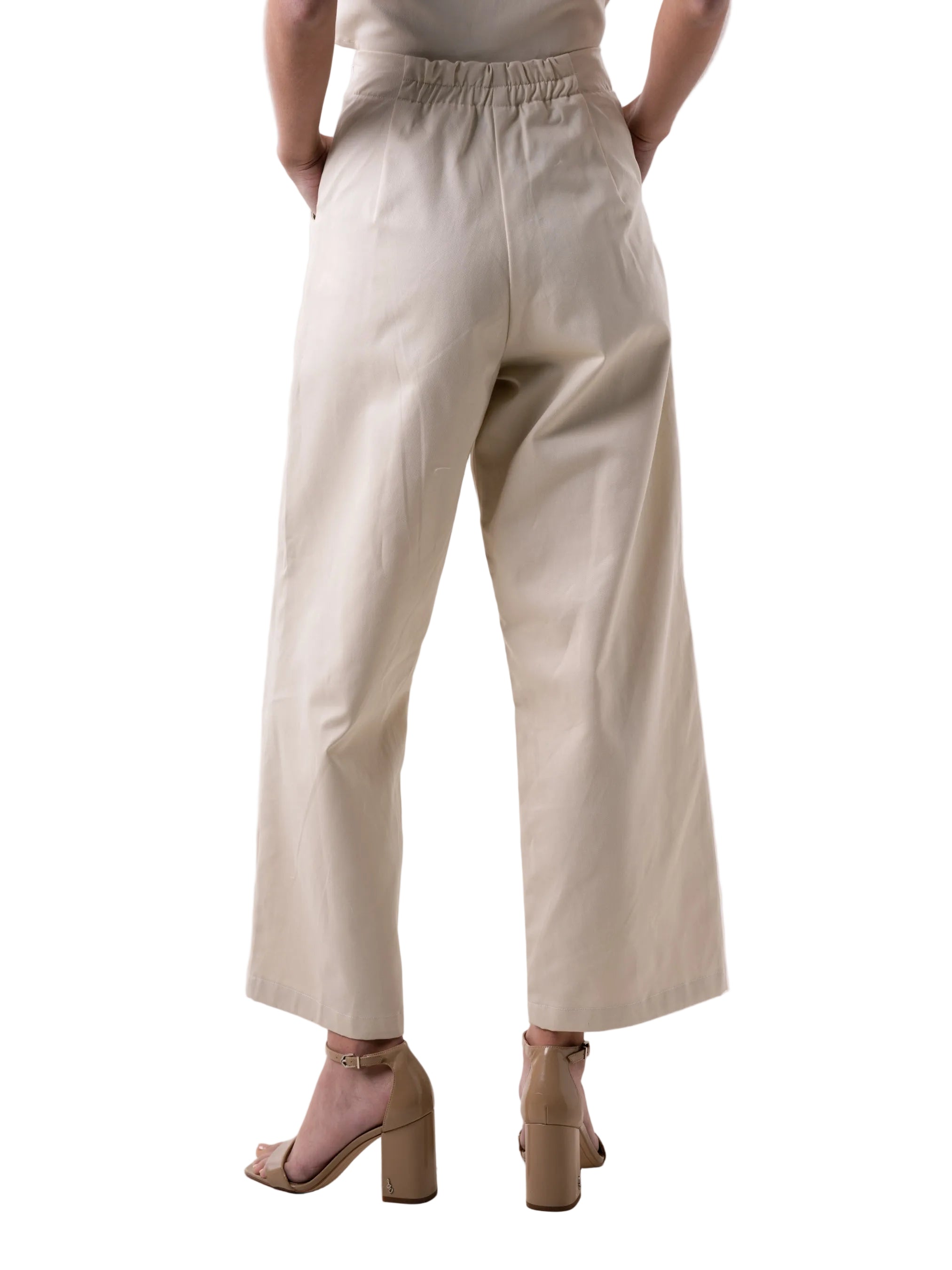 Pant with high waisted relaxed silhouette, elastic back waist band, side zipper closure, and front pockets adorned with knot details.