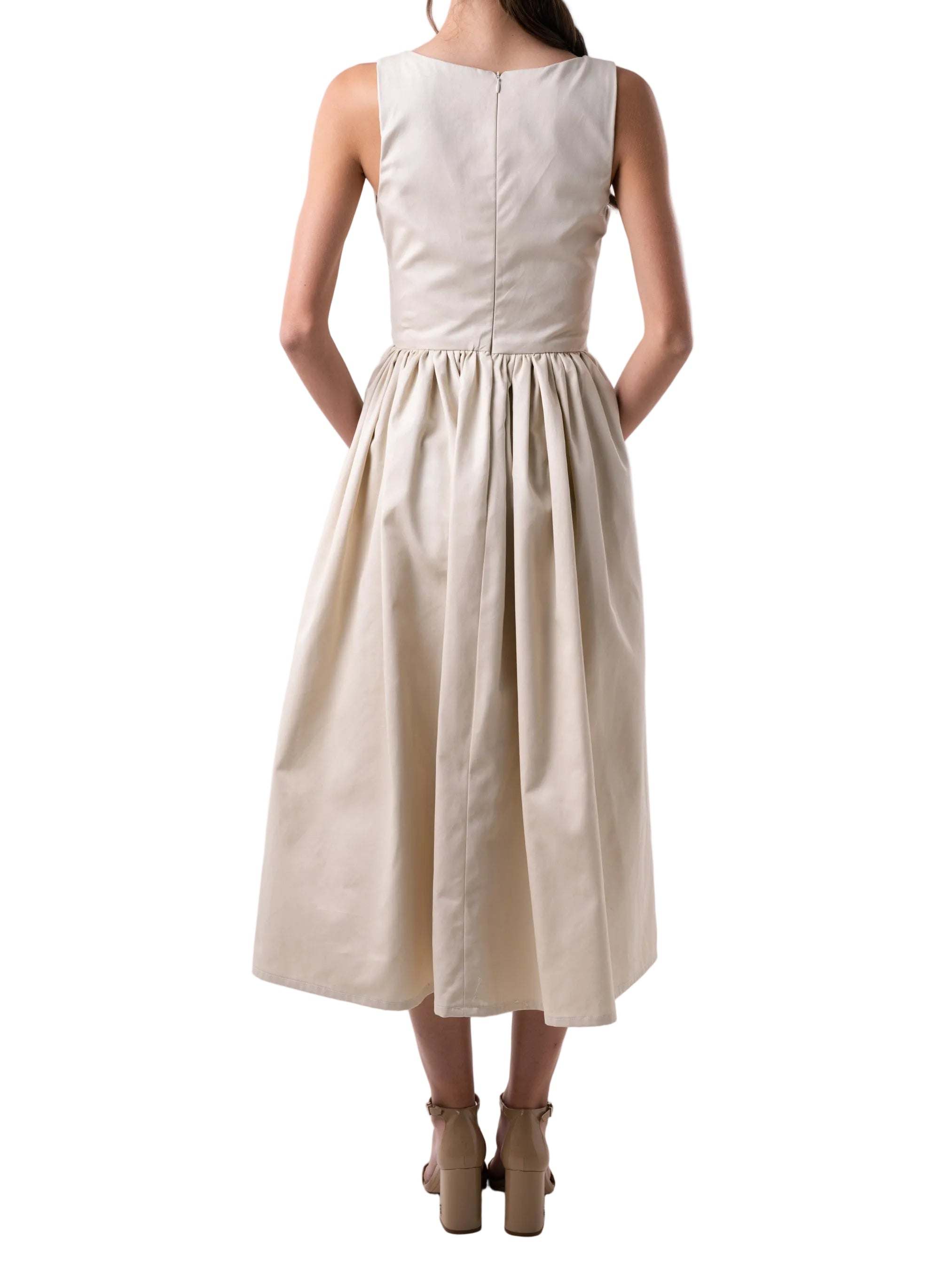 Dress features a V neck silhouette with a gathered puff skirt and cut out details at the torso, finished with two knots and back zipper closure.