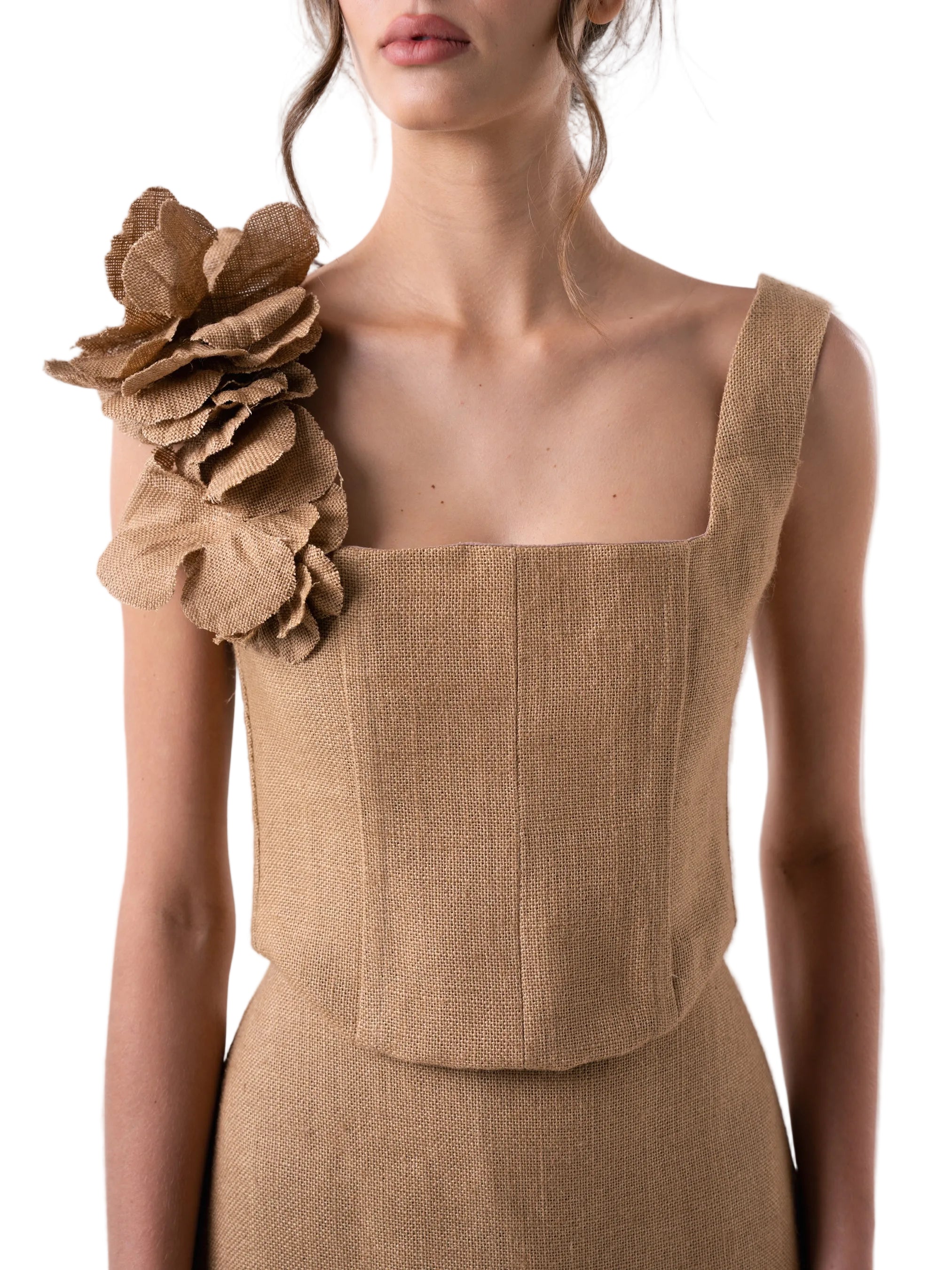 Bustier that features a fully boned bodice with straps and back lace up closure for adjustable fit, adorned by hand sewn artisanal flowers in one of the straps.