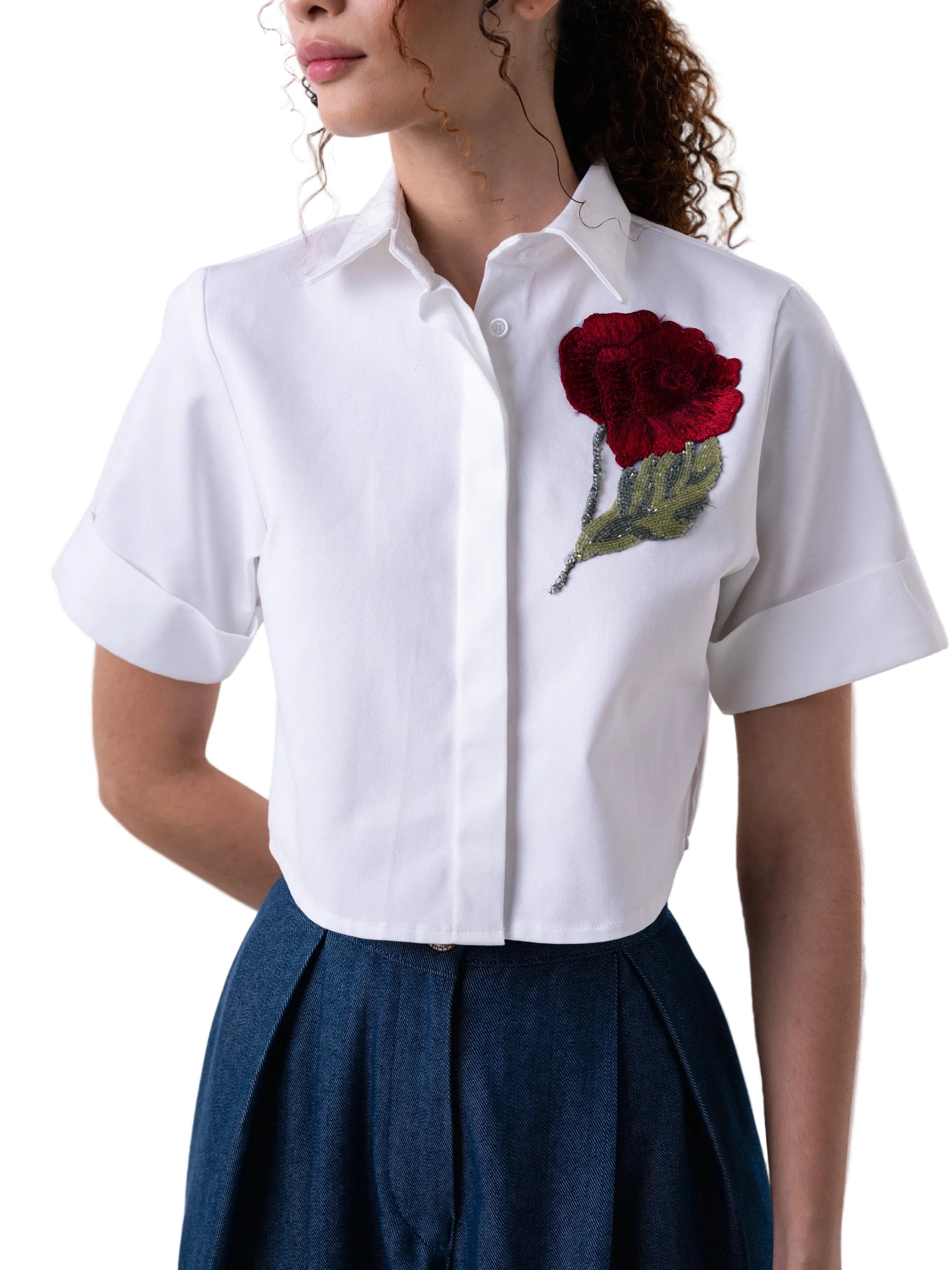 White short sleeve classic button down top, with a cropped silhouette, cuff detail and floral motif embroidery.