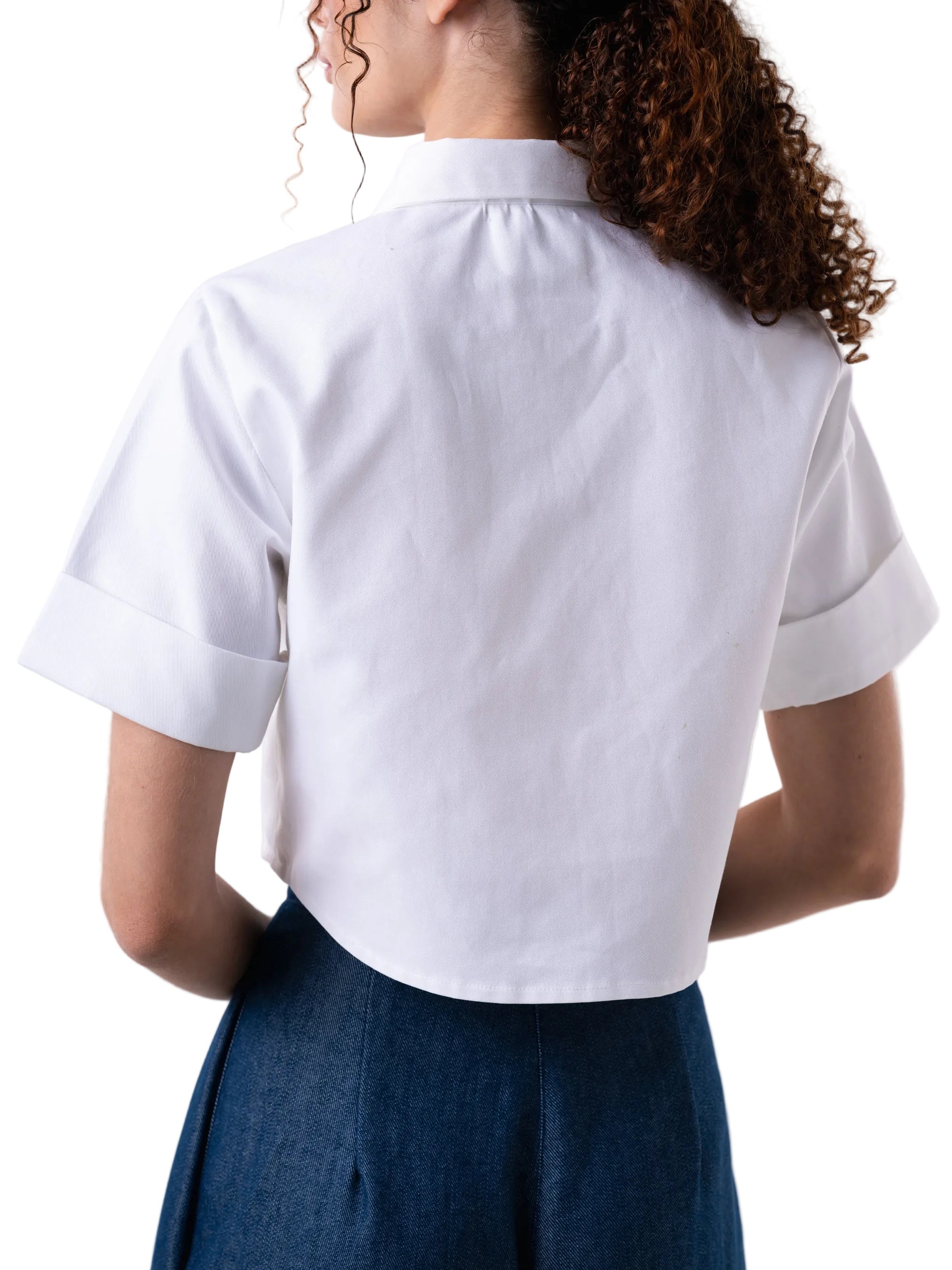 White short sleeve classic button down top, with a cropped silhouette, cuff detail and floral motif embroidery.