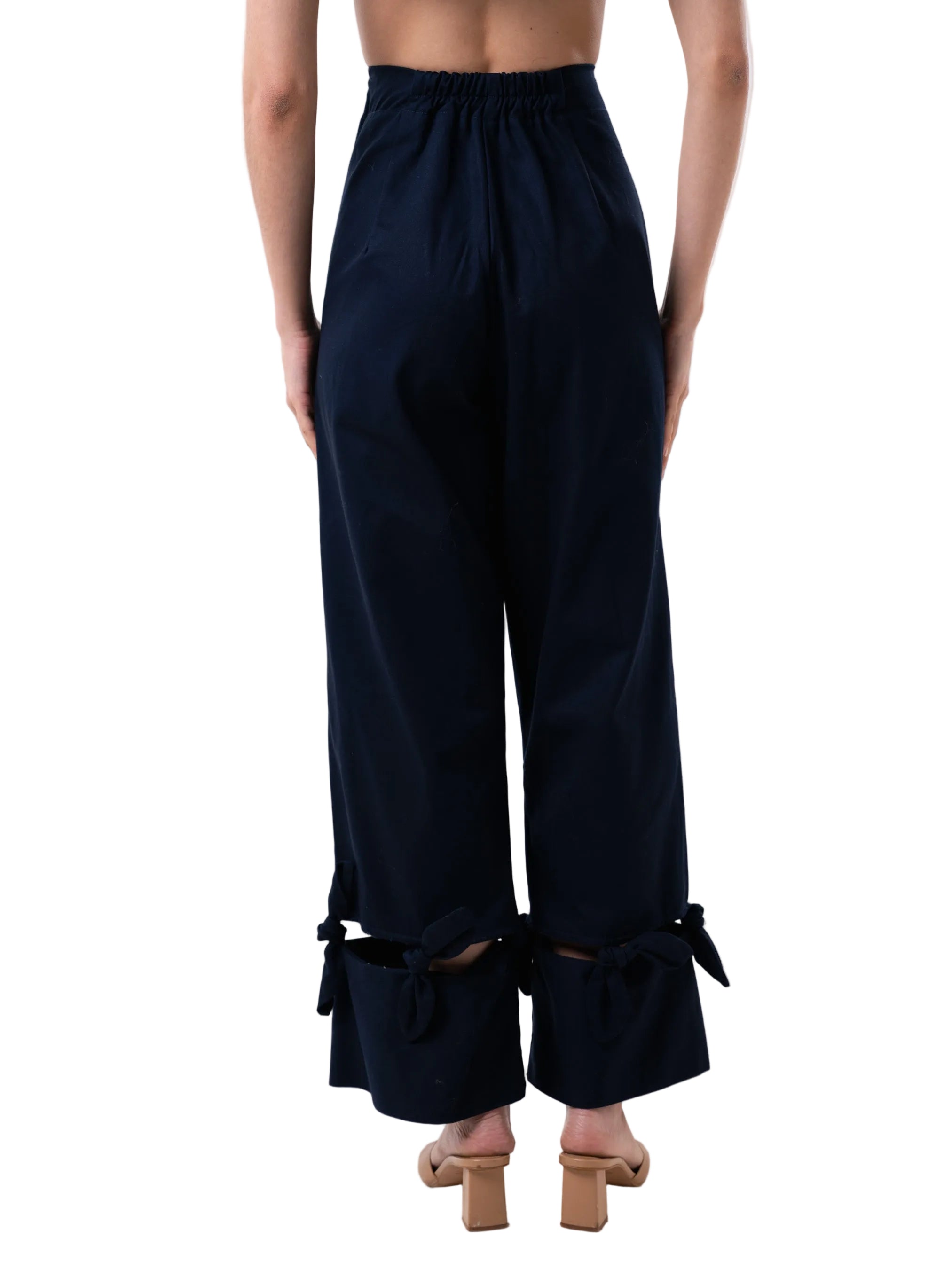 Navy pant with a high-waisted, wide-leg silhouette with bow details at the hem.