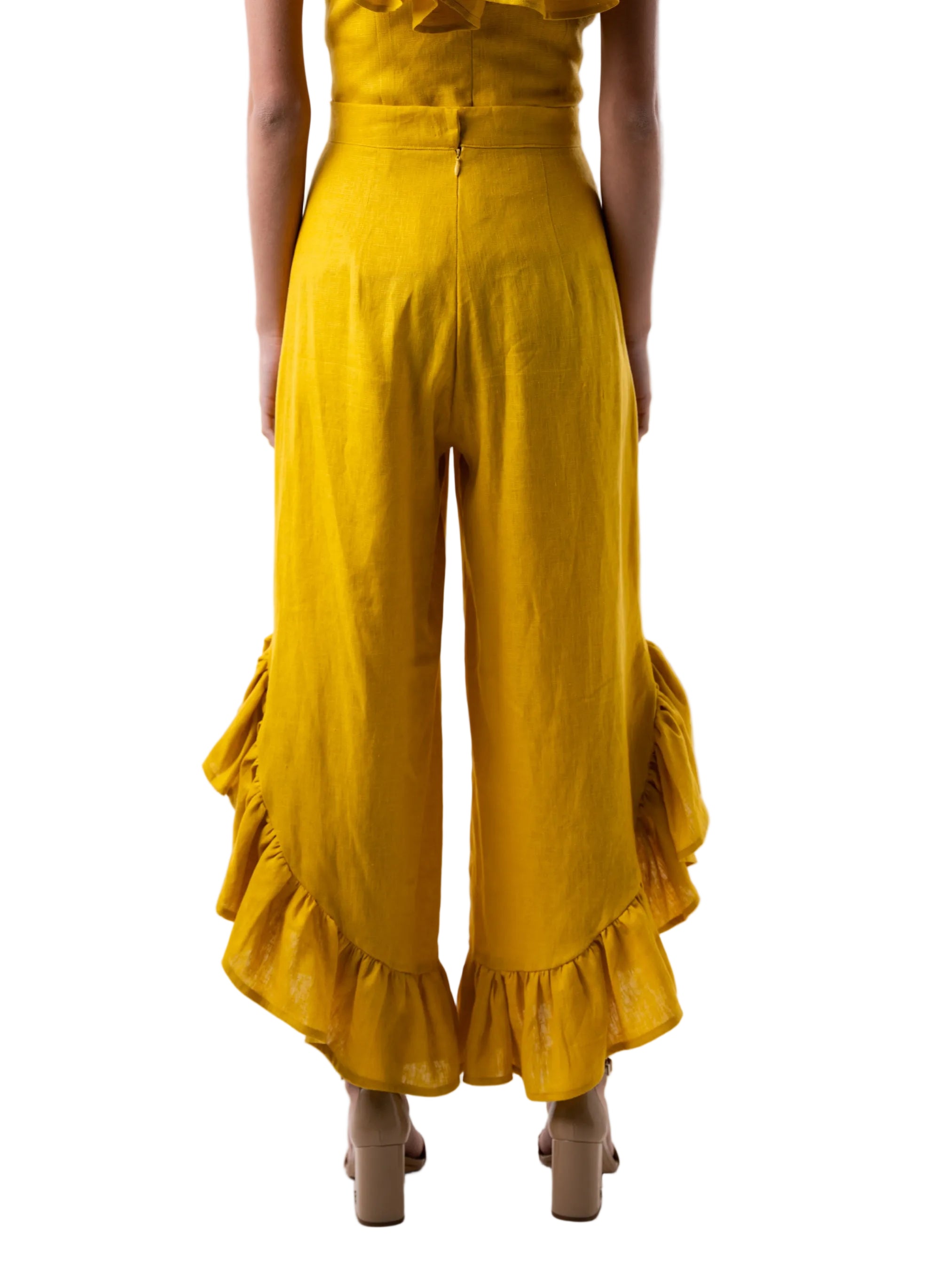 Pant that features a high waisted ankle length pant with curved ruffle detail at the hem.