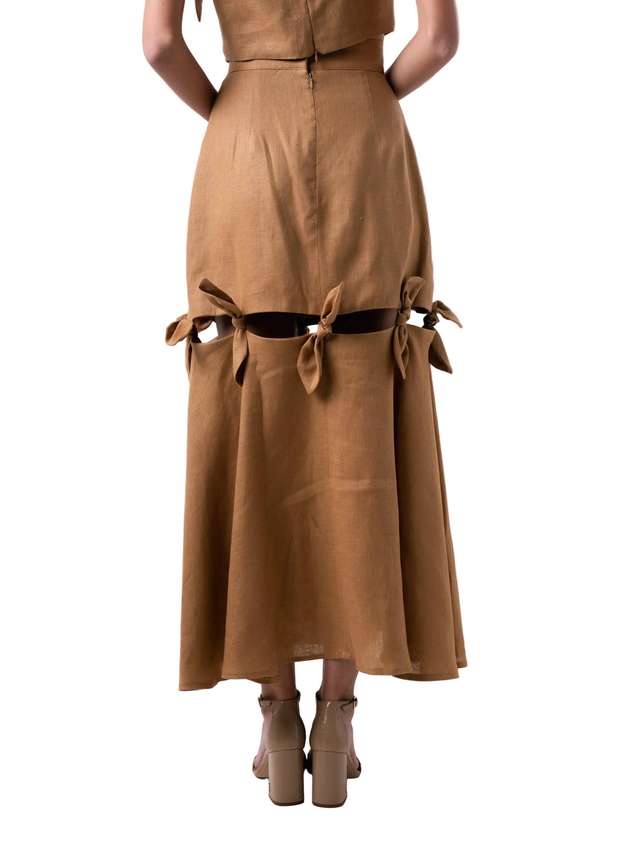 Fit and flare high waisted below the knee skirt, with exposed cutout and knot details that attach the fitted body to the flared panel, with back zipper closure.