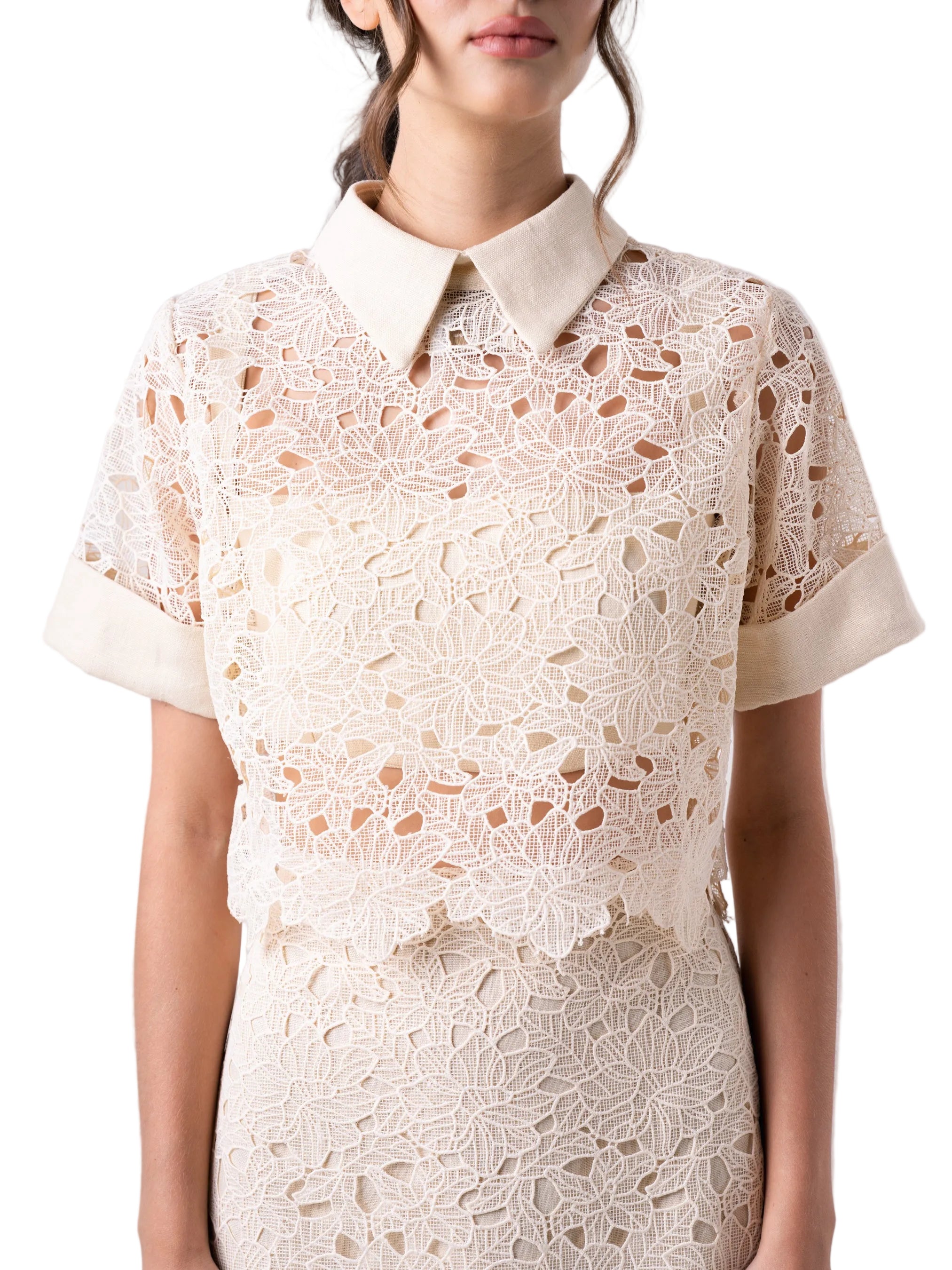 Top that features a short sleeve cropped boxy silhouette, with cuff detail, classic collar and back button down closure.