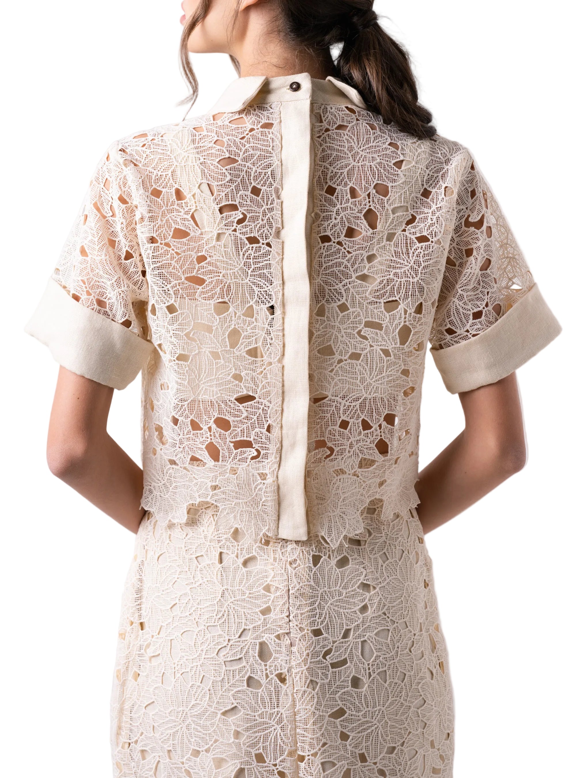 Top that features a short sleeve cropped boxy silhouette, with cuff detail, classic collar and back button down closure.