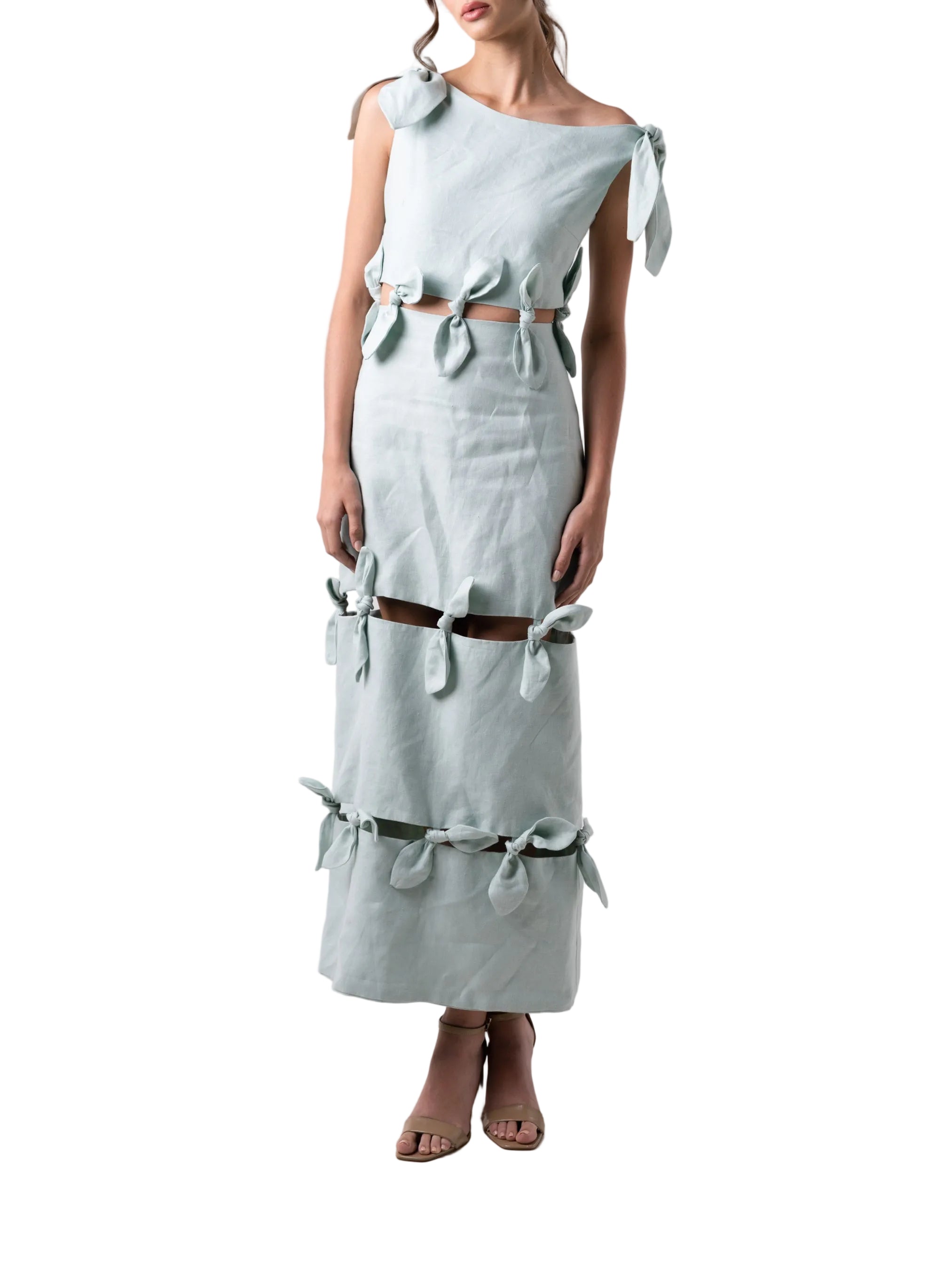 Dress features an ankle length straight silhouette, single dropped shoulder with cut out details and petal knots down the body.