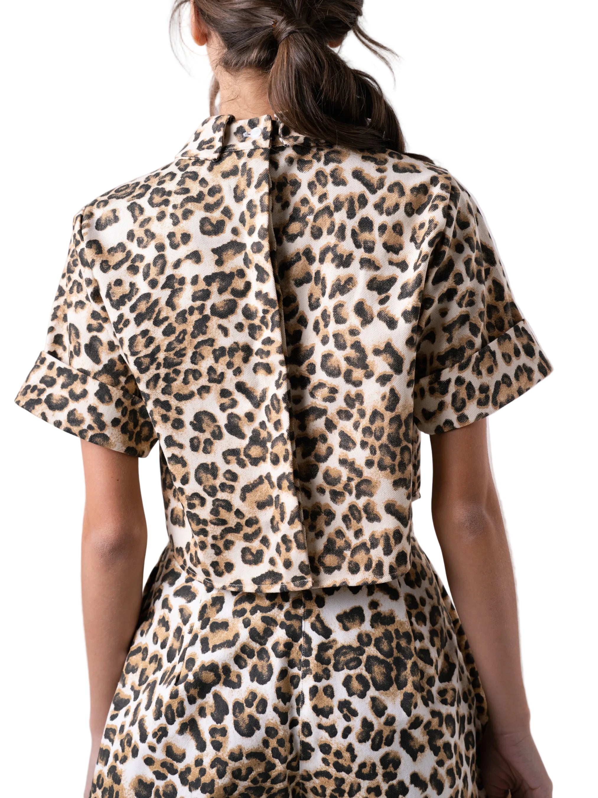 Top that features a classic collar with short sleeves with a cuff detail, and back button down closure.