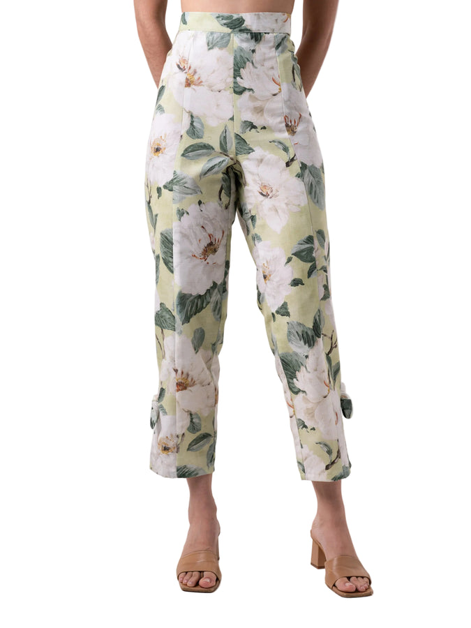 Pants that feature a high waist straight leg silhouette with slit detail at the ankle with knot detail, and back zipper closure.