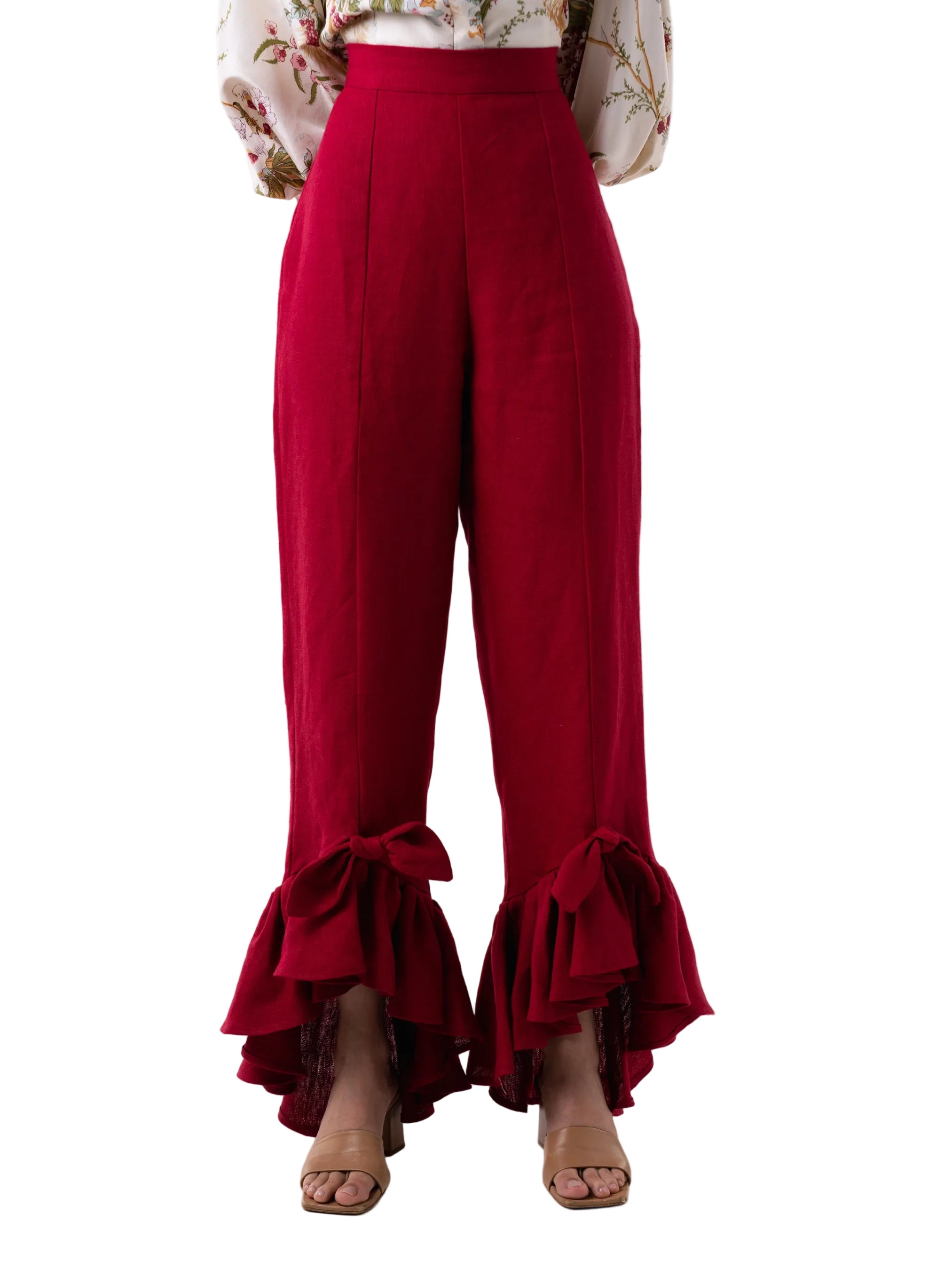 Pant that feature a straight leg high waisted silhouette with a cascading ruffle at the ankle with knot detail, and back zipper closure.