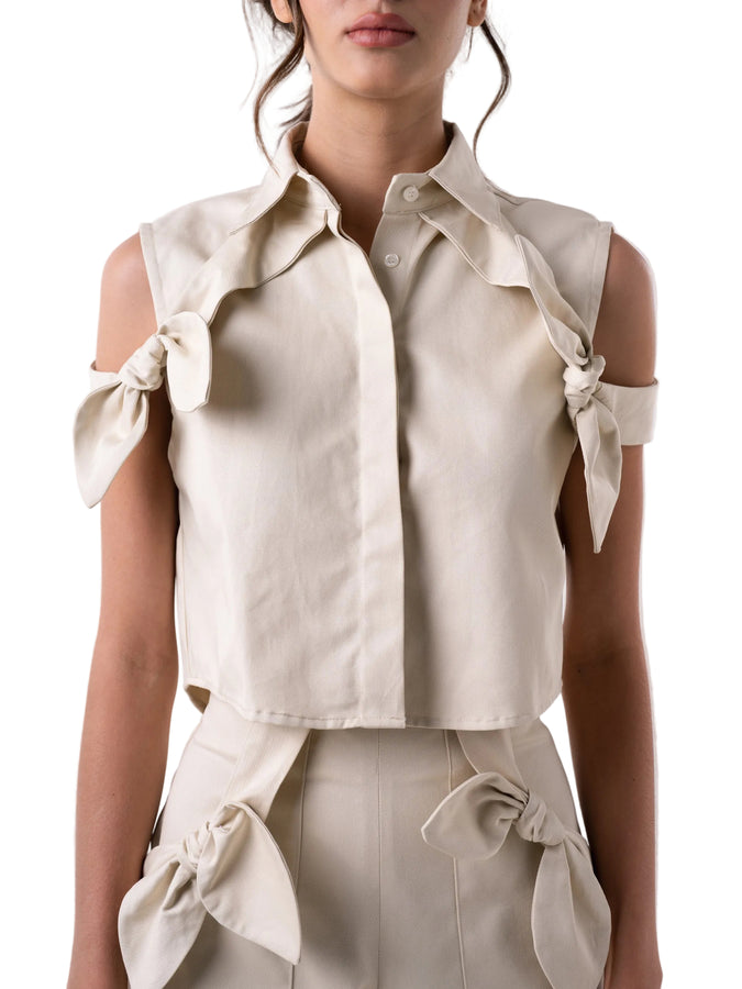 Boxy cropped top silhouette with collar and front placket, with off the shoulder straps.