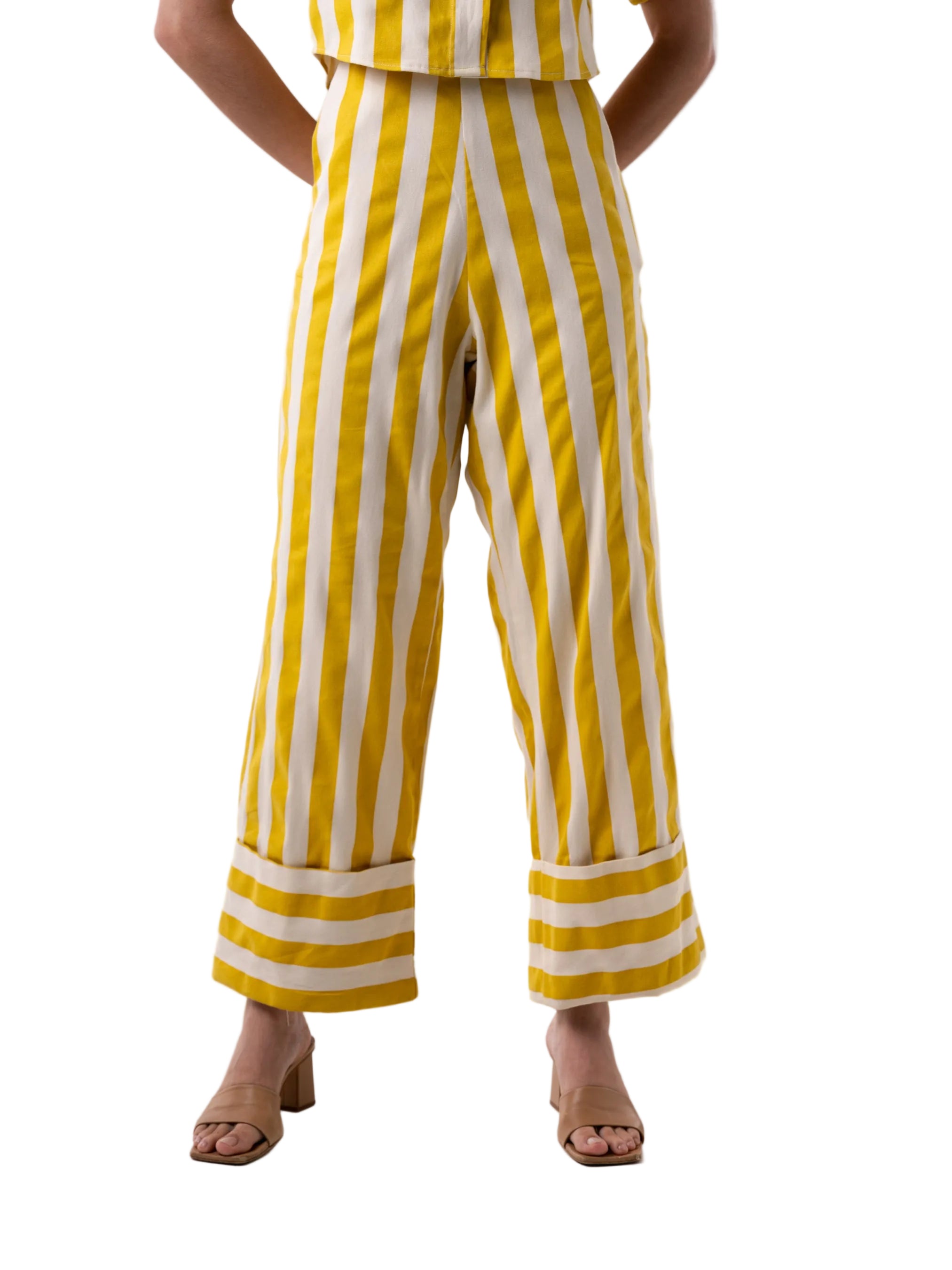 Pant that features a high waisted wide leg silhouette pant, with oversized cuff at the hem, front pockets.