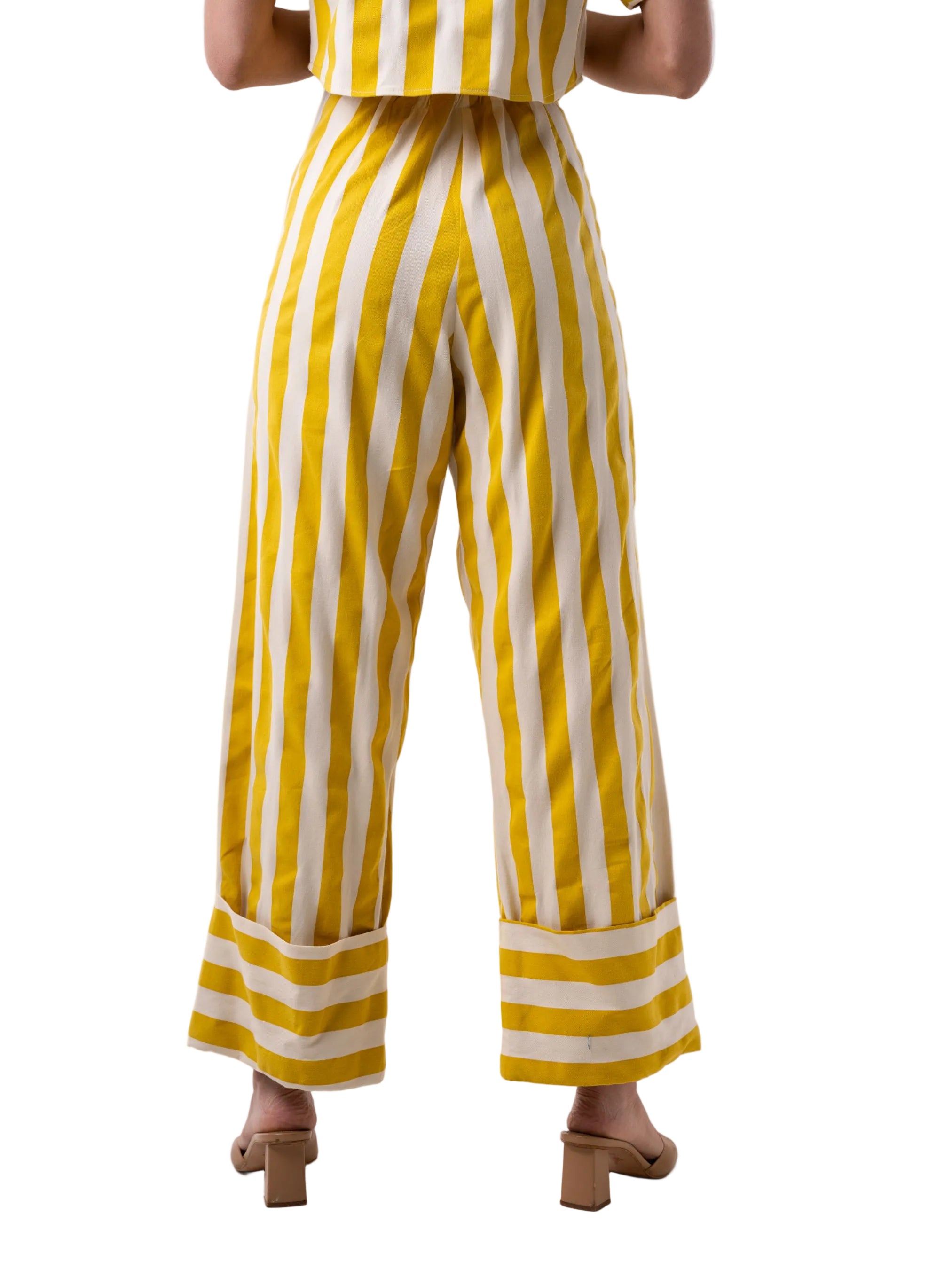 Pant that features a high waisted wide leg silhouette pant, with oversized cuff at the hem, front pockets.
