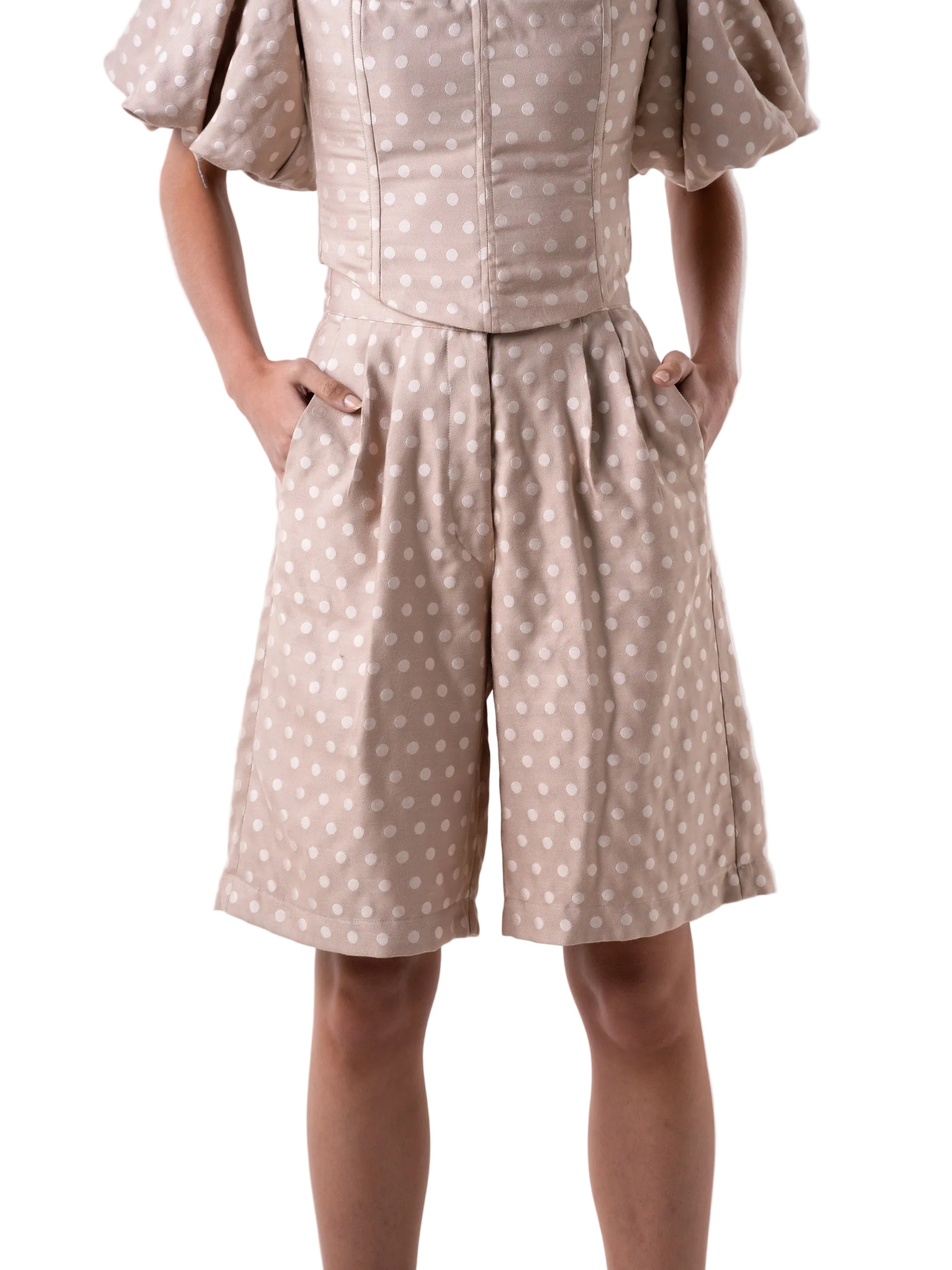 Bermudas that feature a high waisted silhouette with front pleats, and wide leg cut.