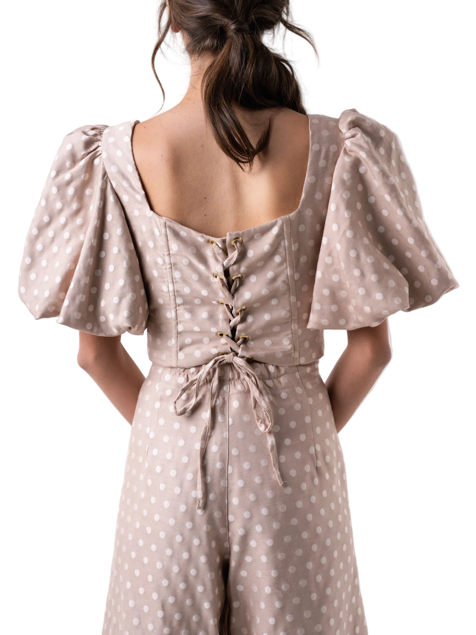 Top that features a fully boned dropped waist corset style silhouette, with back lace up closure and puff sleeves.