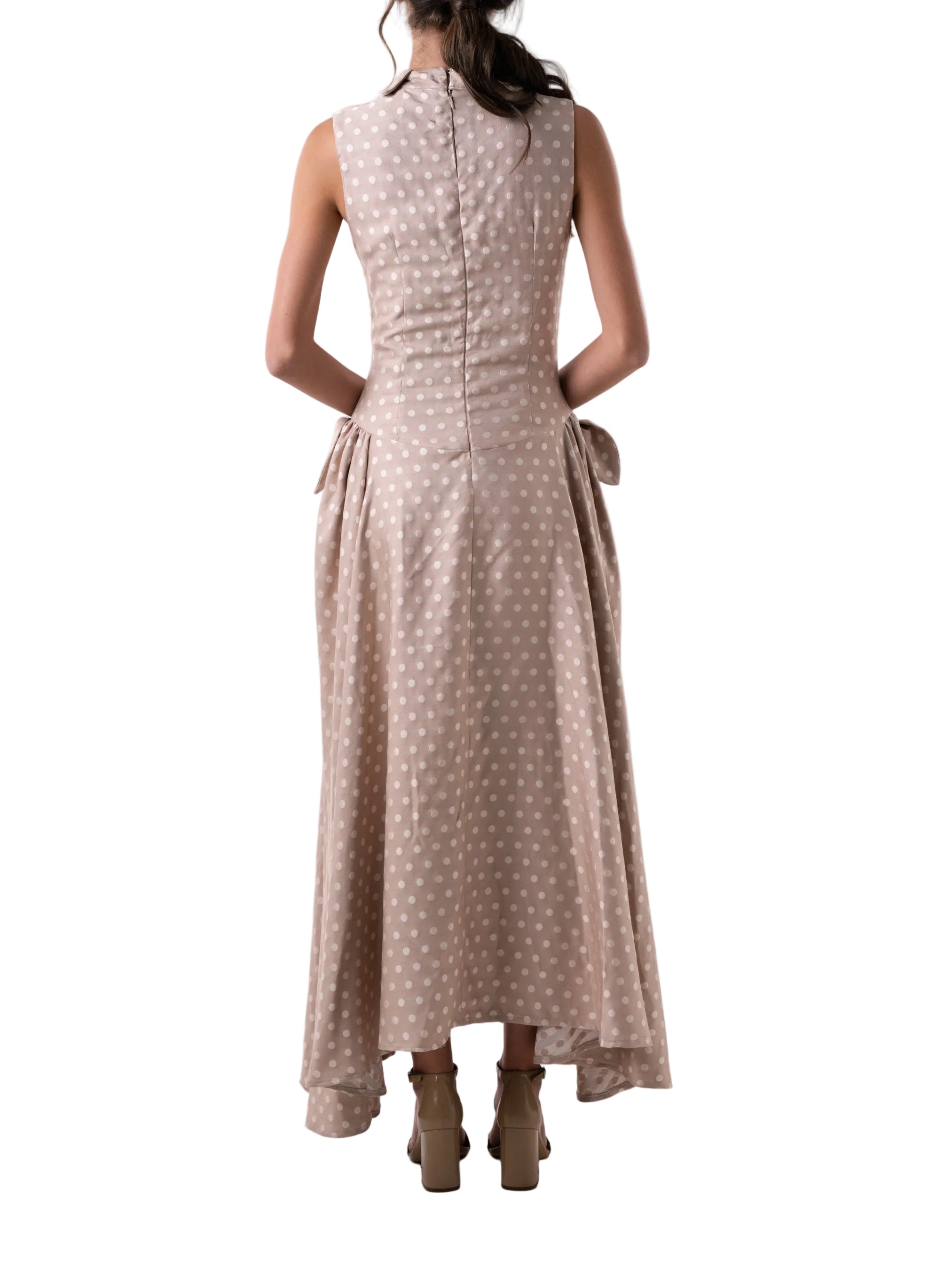 Dress that features a fit and flare dropped waist and ankle length silhouette, classic collar, petal knot detail and back zipper closure.