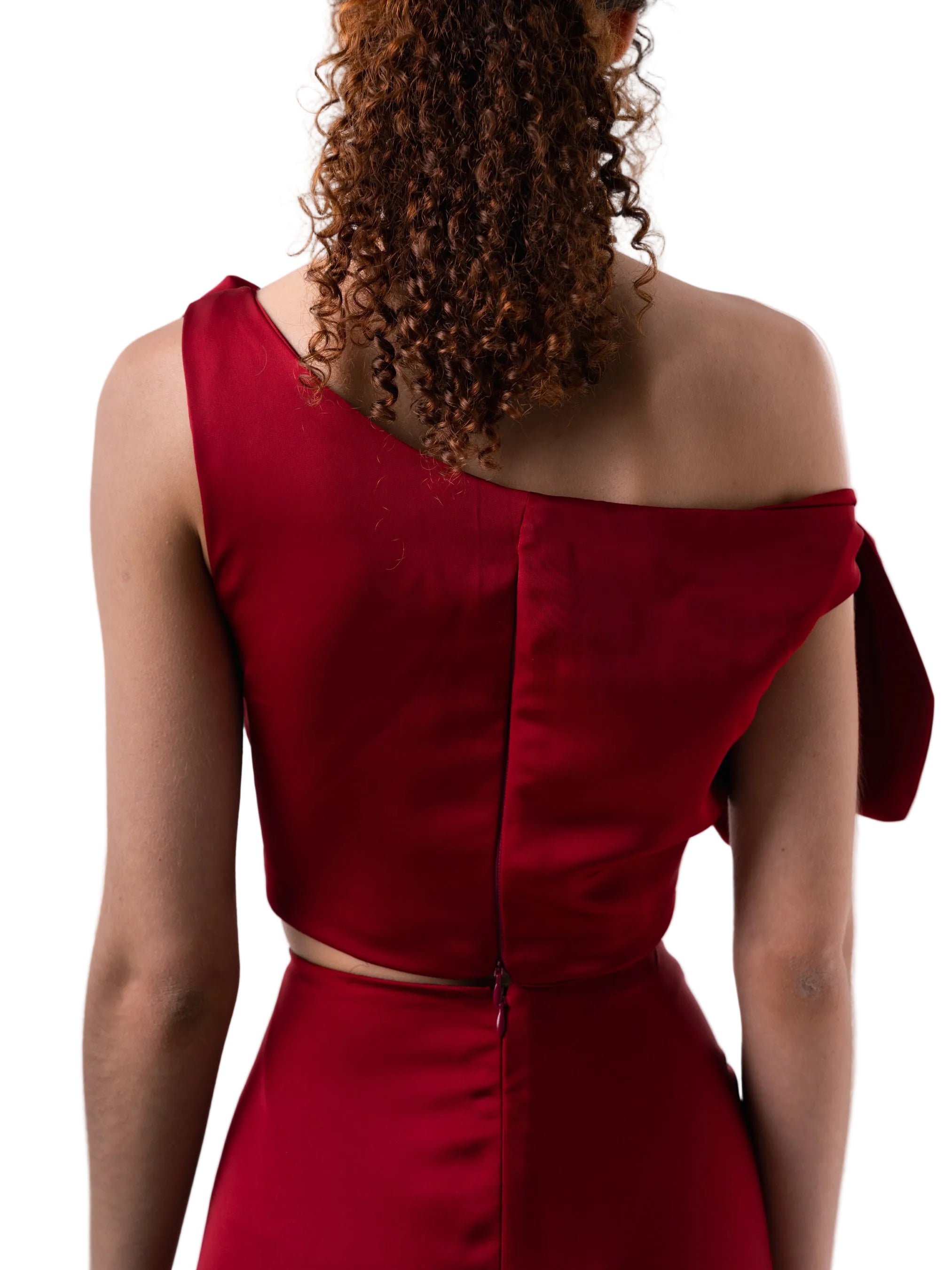 Top that features a cropped loose silhouette with dropped shoulders detail, and back zipper closure.