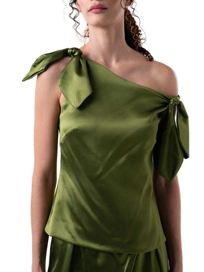 Top that features a relaxed drop waist silhouette with single drop shoulder and petal knot detail.