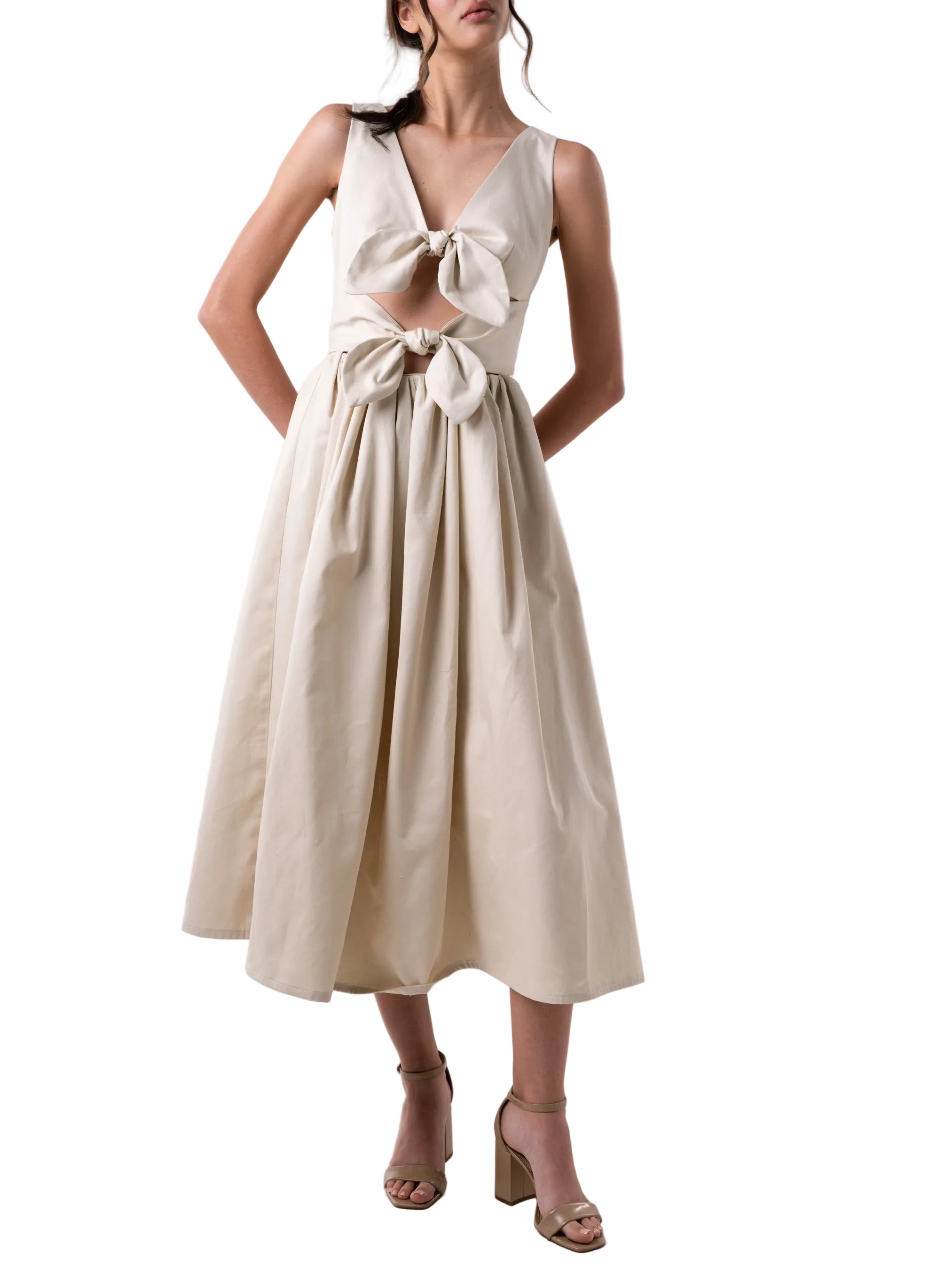 Dress features a V neck silhouette with a gathered puff skirt and cut out details at the torso, finished with two knots and back zipper closure.