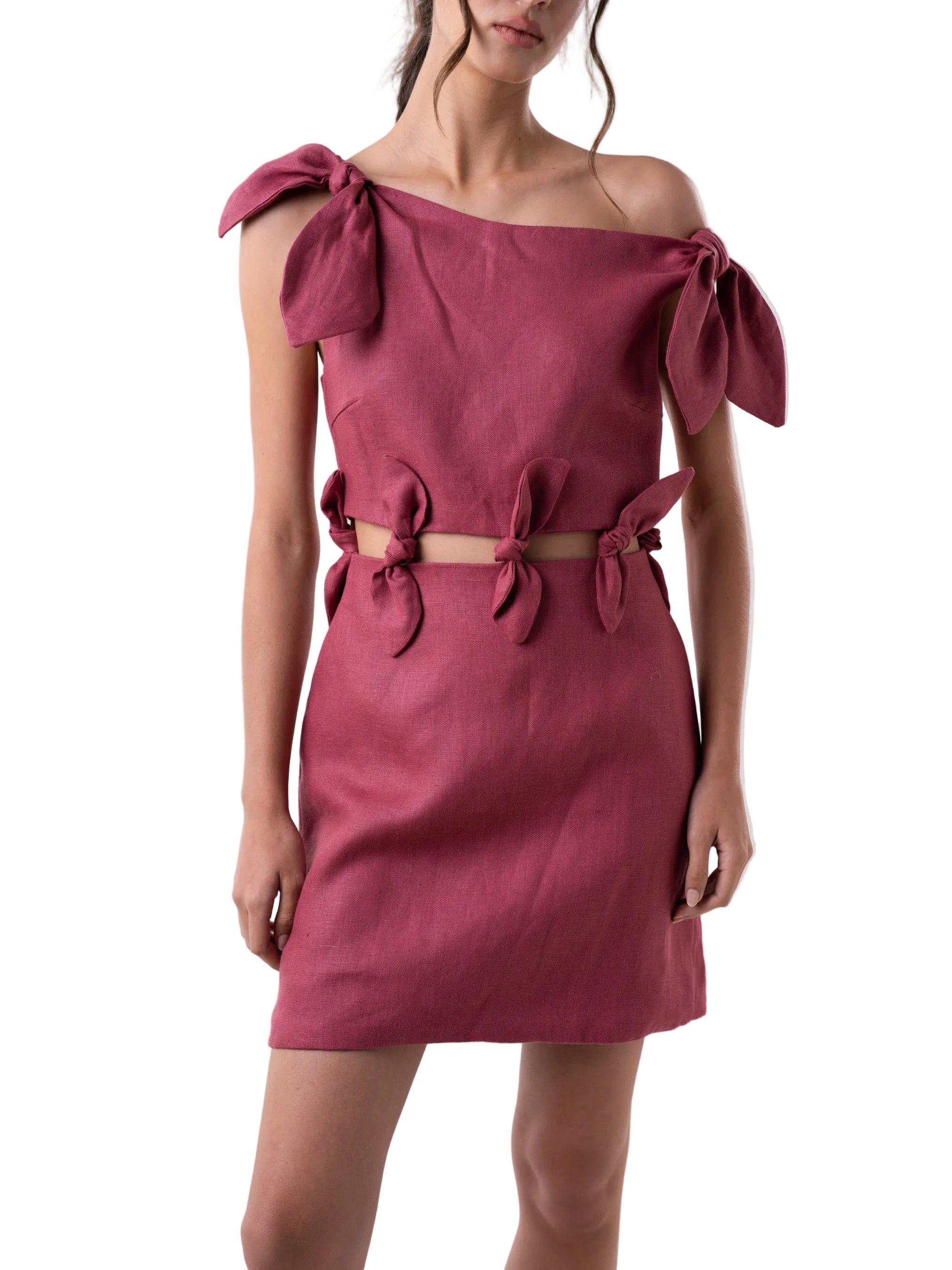 Dress with a loose silhouette, above the knee length, and cut out detail above the waist, adorned with knot details at the waist cut out, and shoulders.