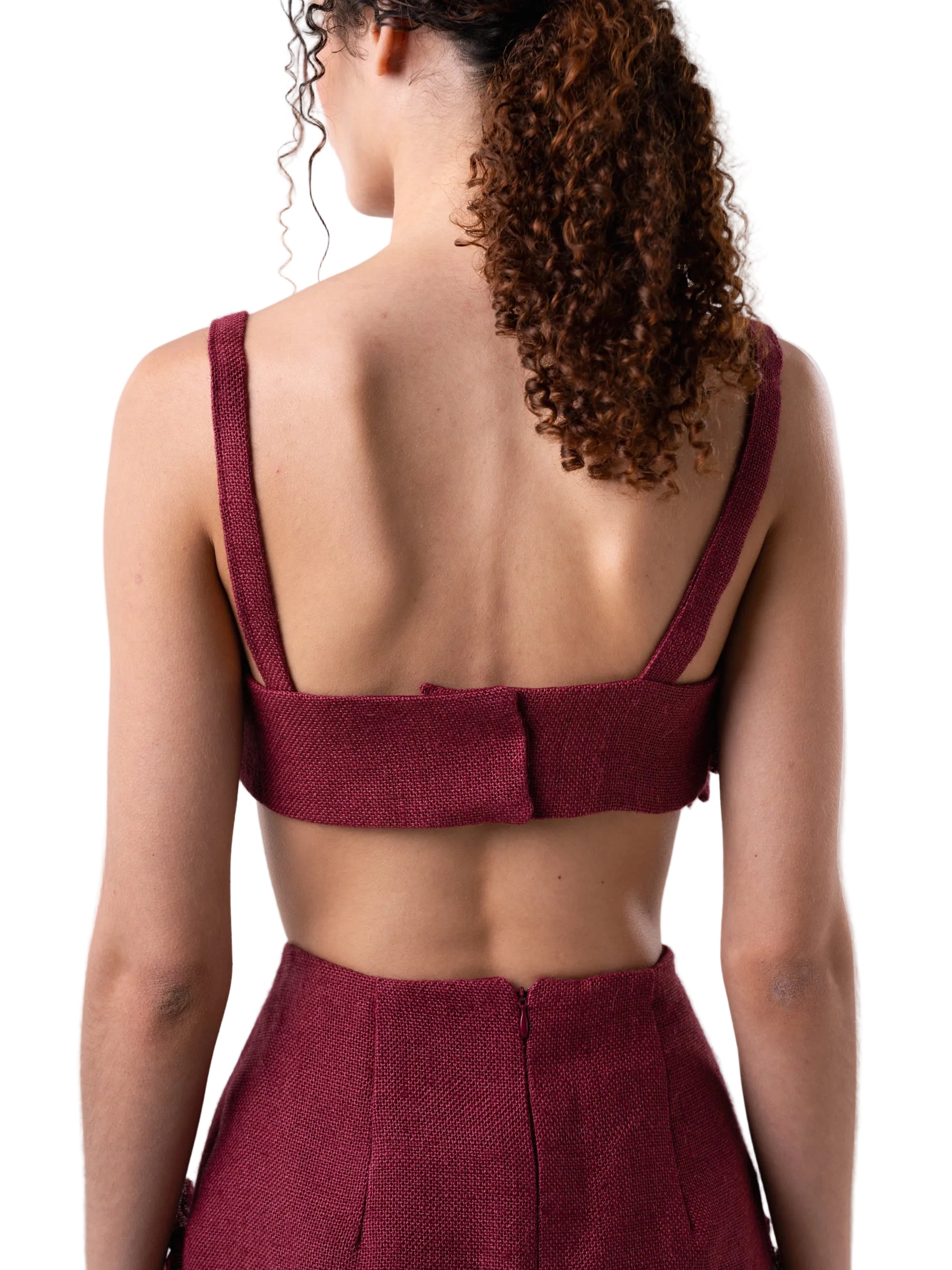 Cropped top with straps, hand sewn artisanal flower details and back button closure.