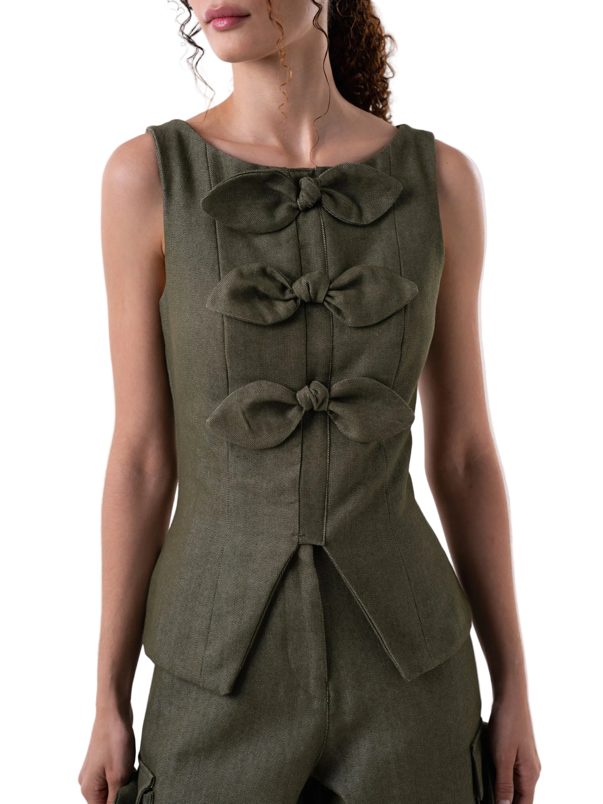 Sleeveless vest like top, with fitted silhouette, petal knot detail down the front and back zipper closure.