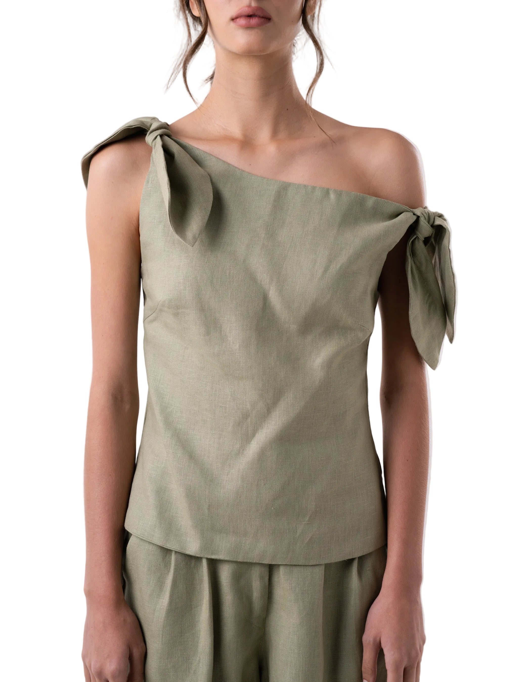 Top features a relaxed drop waist silhouette with single drop shoulder and petal knot detail.