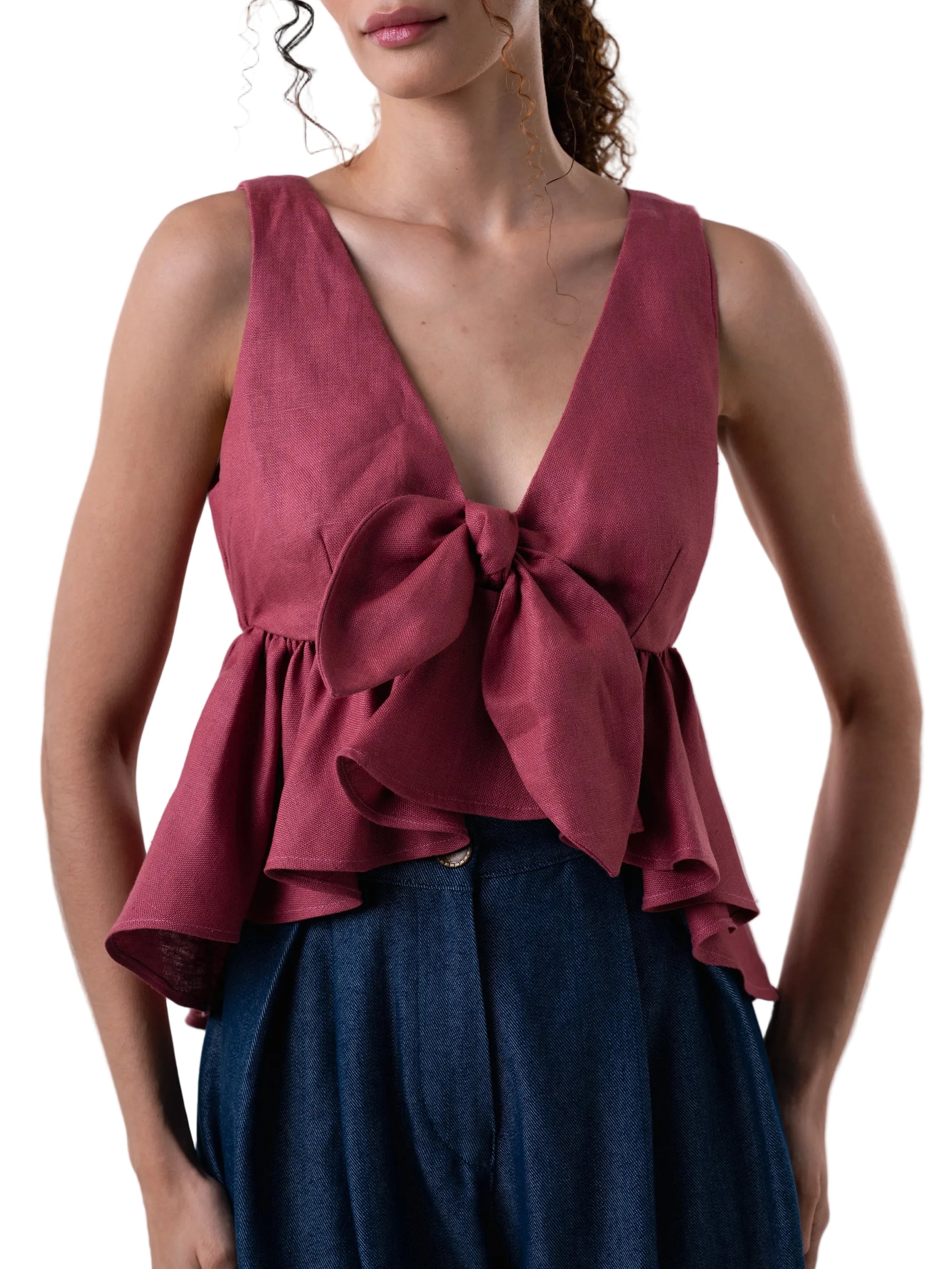 Top features a V neck empire waist, fit and flare silhouette, with back zipper closure, circular ruffle and knot detail at the front.