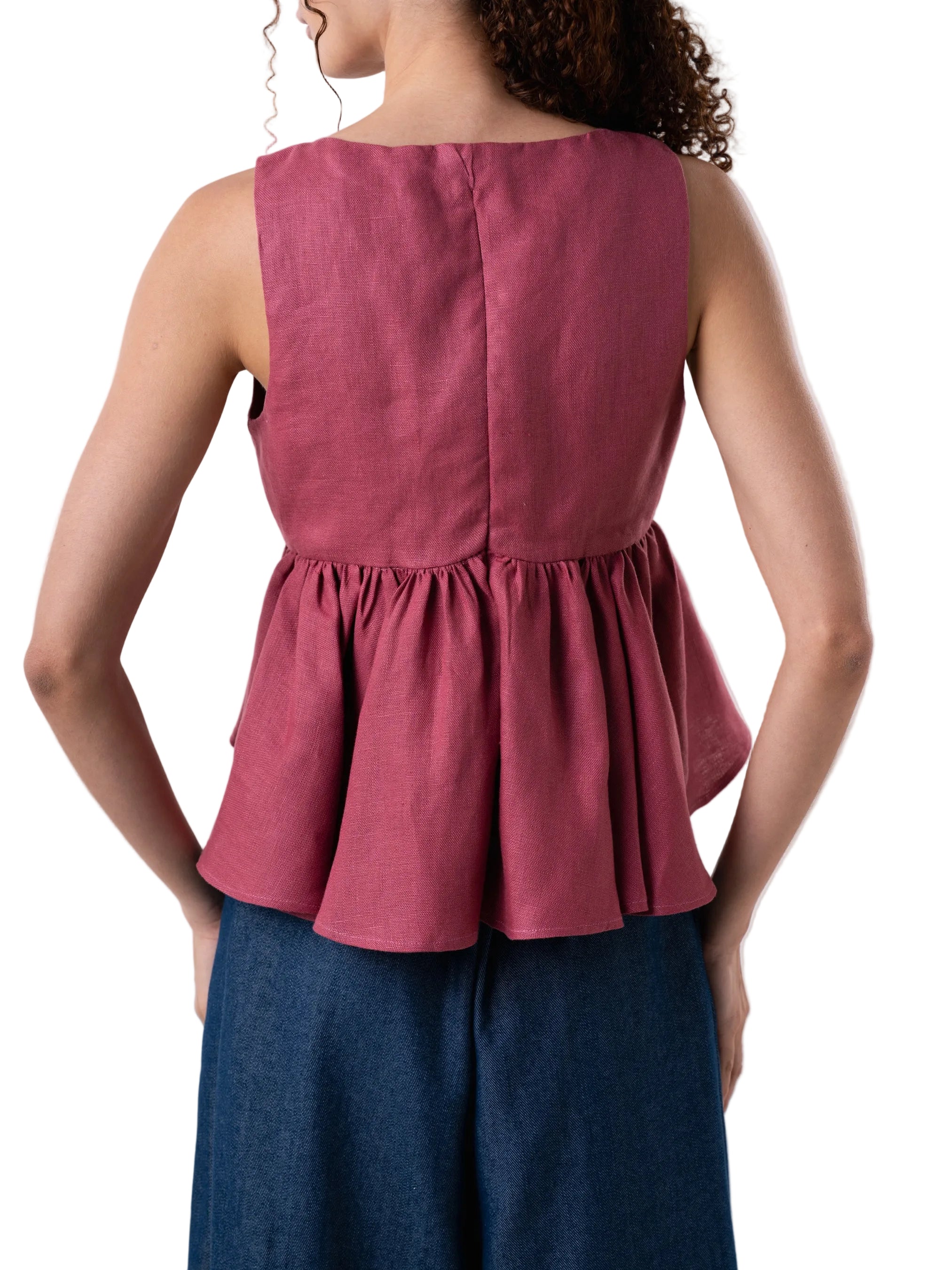 Top features a V neck empire waist, fit and flare silhouette, with back zipper closure, circular ruffle and knot detail at the front.