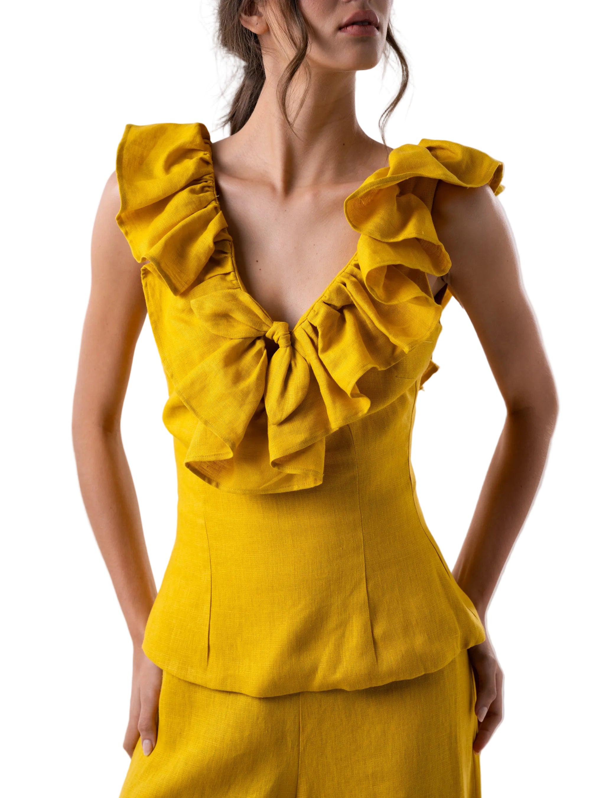 Top that features a sleeve less fitted silhouette with ruffle details around the neckline and back zipper closure.