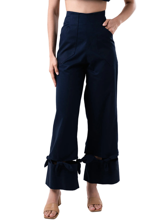 Navy pant with a high-waisted, wide-leg silhouette with bow details at the hem.
