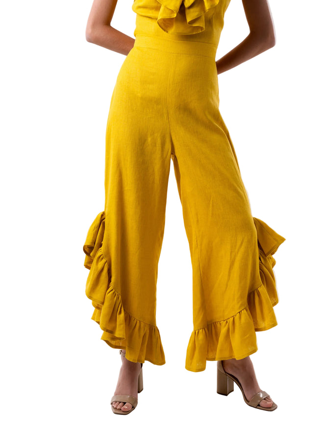 Pant that features a high waisted ankle length pant with curved ruffle detail at the hem.