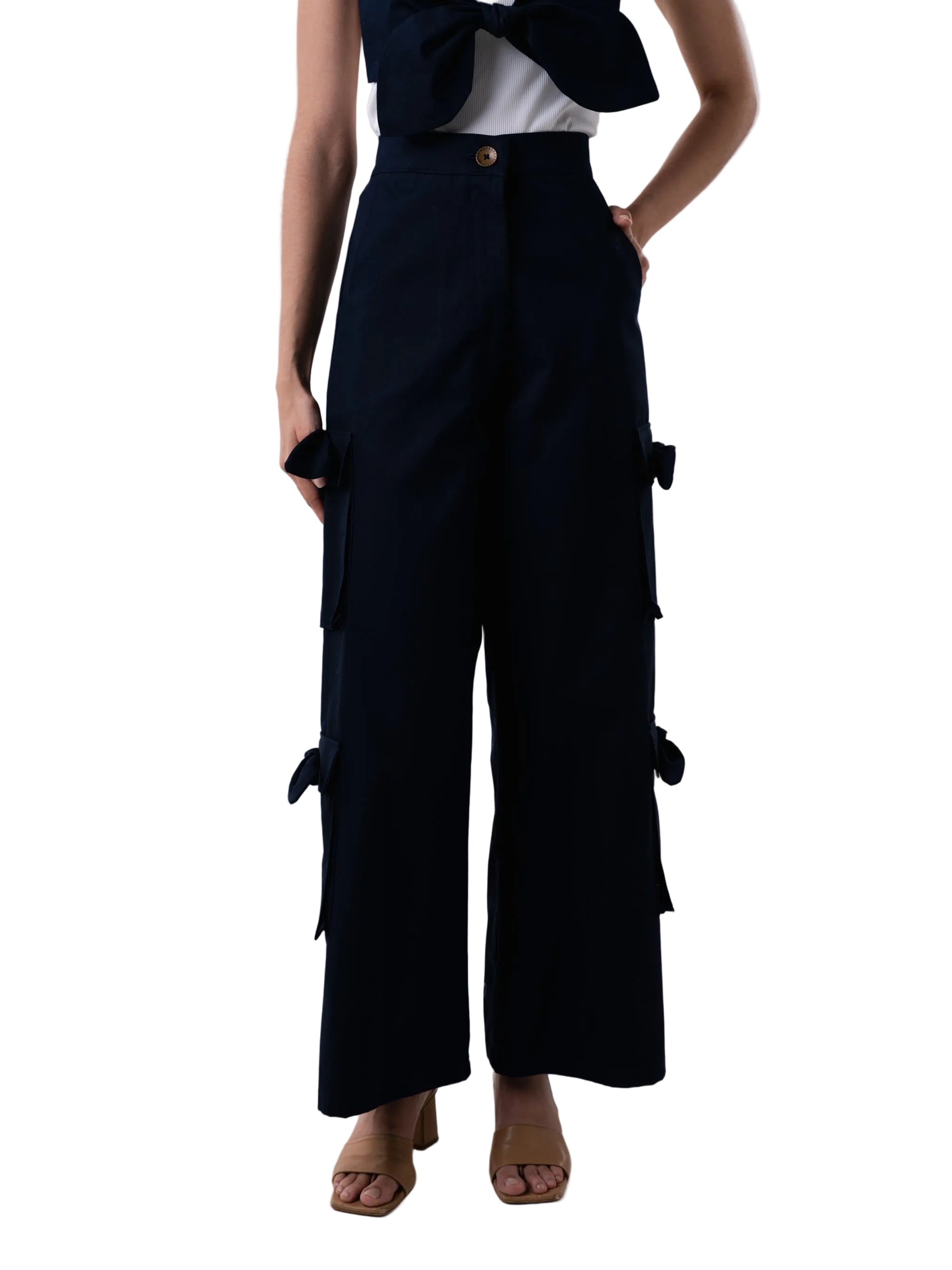 Pant with high waisted cargo style, front zipper, and oversized pockets down the leg with knot details. 